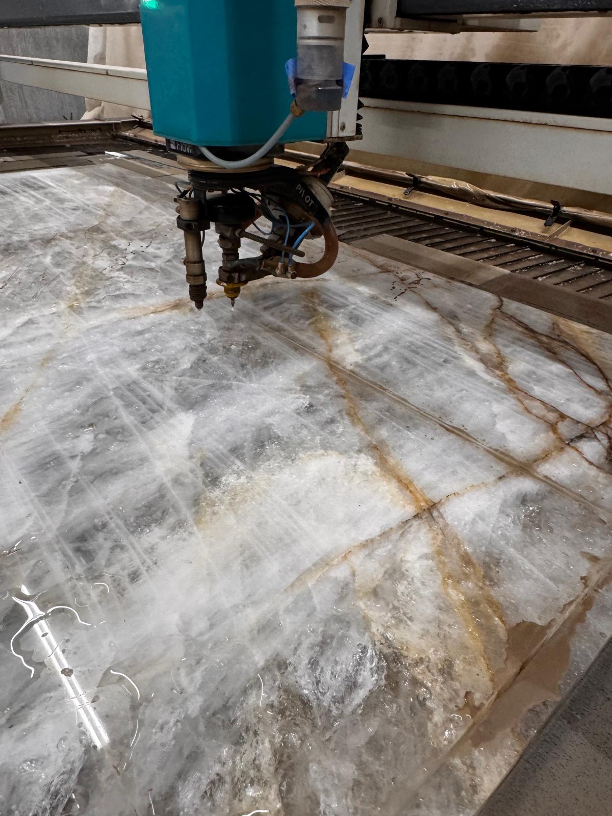 Flow Mach 200c cutting large quartzite slab with gold veining