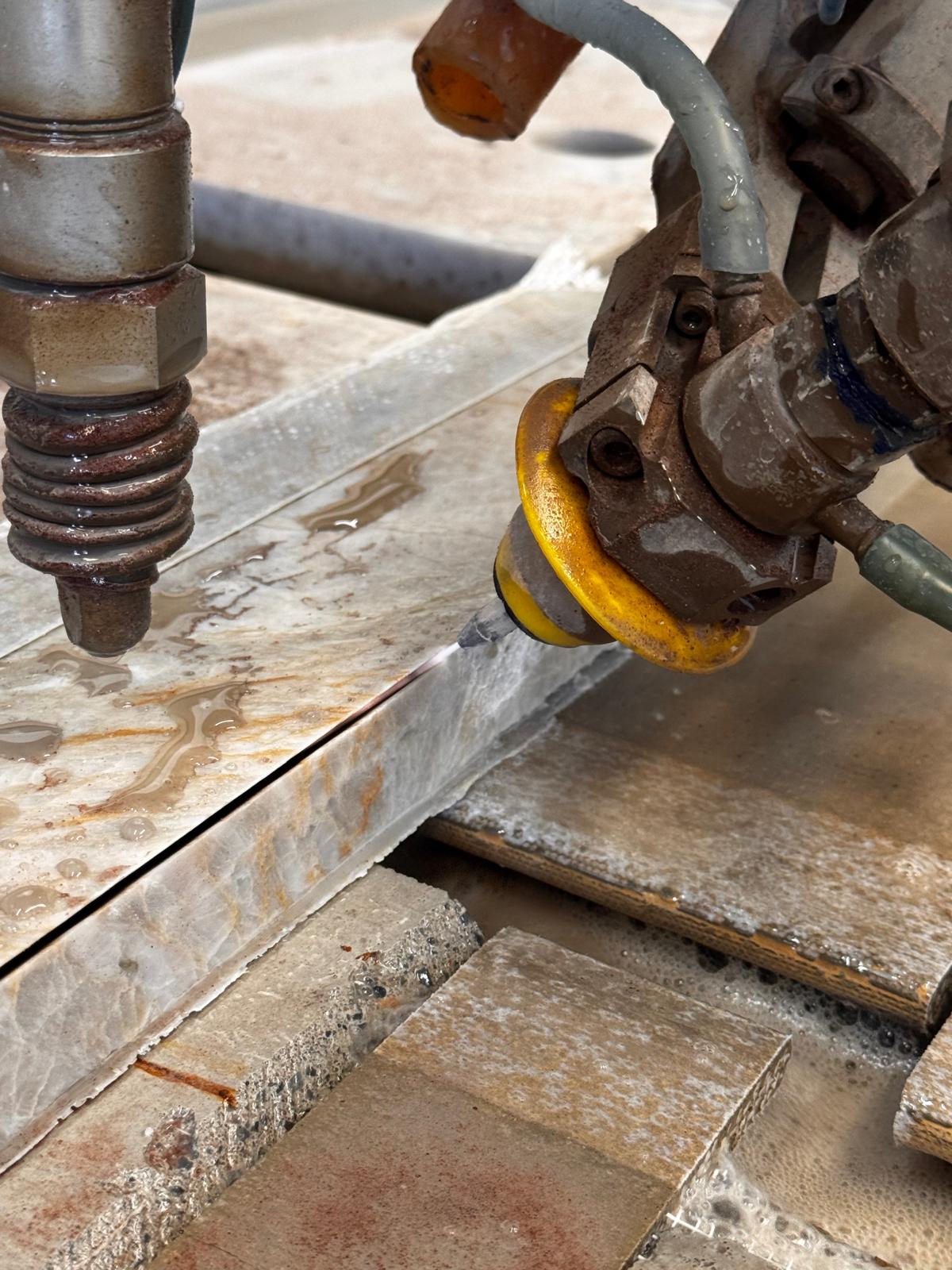 Close-up of Pivot+ 5-axis cutting head performing bevel cut