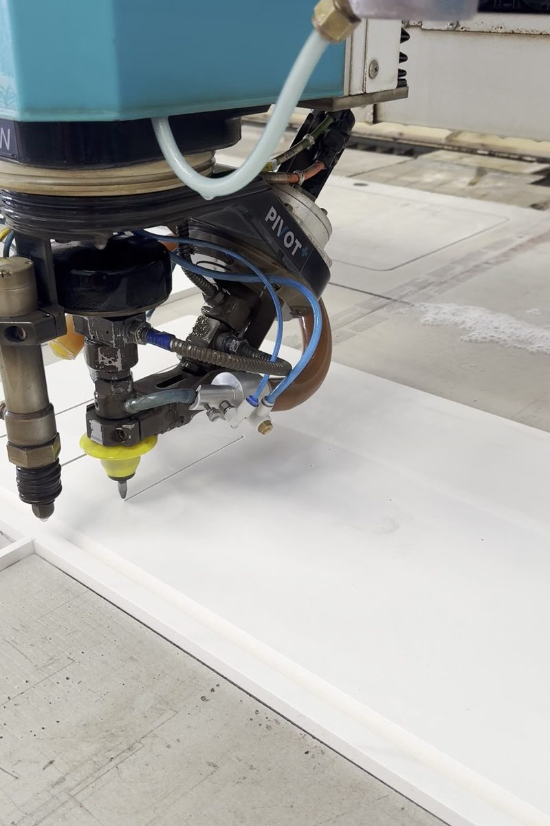 Flow Mach 200c waterjet cutting machine head in action