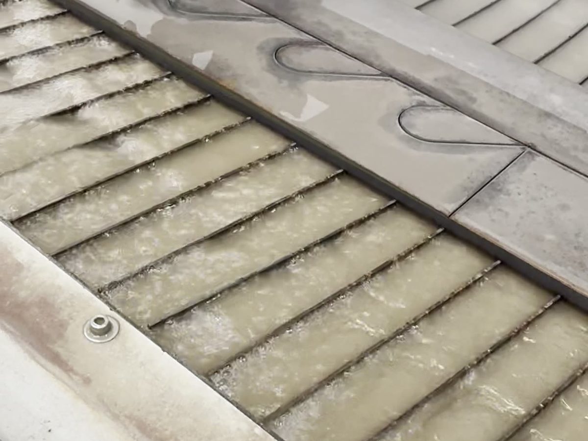 Pivot+ 5-axis waterjet cutting head detail with abrasive nozzle