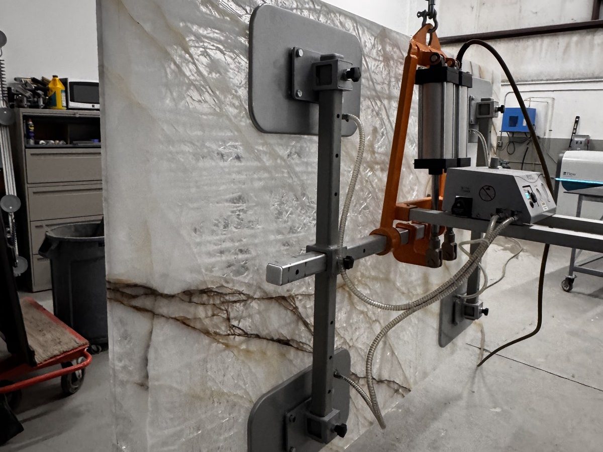 Quartzite slab with veining being precision-cut by waterjet